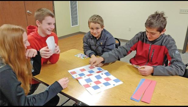 ST. MARCUS FAITH FORMATION YOUTH create woven red, white and blue placemats for vets at the St. Cloud VA for their October community service project. (Submitted Photo)