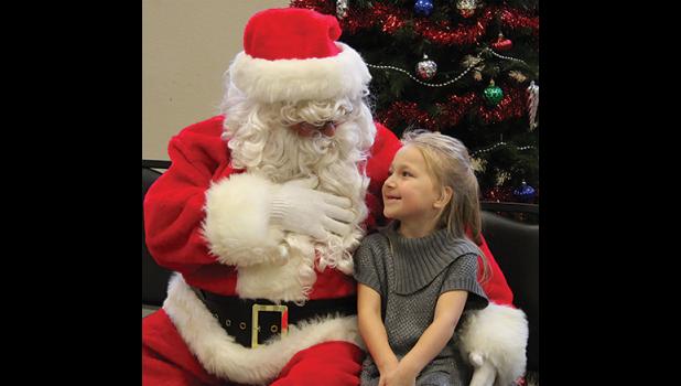  Melady McGowan, 6, talked with St. Nick about her wish list at Saturday’s Clearwater Legion Kids Christmas Party. (Photos by Ken Francis).