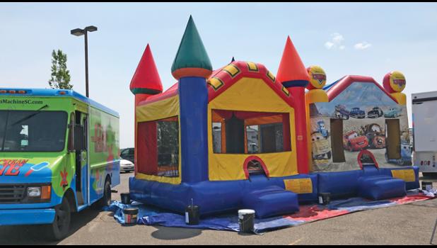 THE BOUNCEY HOUSES — provided by Wruck Portable Rentals — was a popular place for the young kids during last June’s open house at Accurate Automotive. (Photo by Bill Morgan).