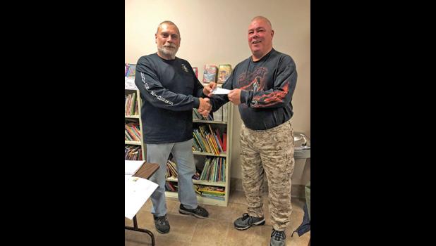 Mark Rinehart handing the check over to Bruce Sobotta of the Healing Nest. (Submitted Photo).