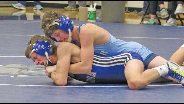 BULLDOG KADEN RISH fights to take down his Mora opponent Nathan Reller during last Thursday’s home triangular. (Photo by Penny Leuthard)