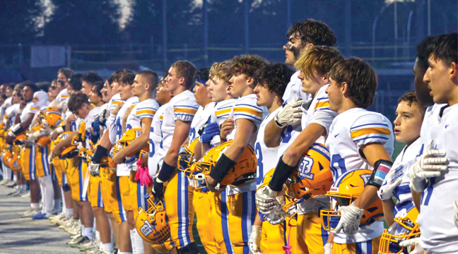 THE BIG LAKE HORNET FOOTBALL TEAM honored the country of the United States with a lineup along the sidelines before last Friday’s game against Providence. (Submitted Photo).