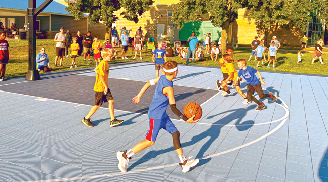 TWENTY-TWO TEAMS of girls/boys from Becker, Annandale, St Cloud, Sartell and Sauk Rapids-Rice — entering grades fourth thru sixth — played in Becker’s annual 3-on-3 tournament at the outdoor basketball court at the Becker Community Center Tuesday evening. Mike+You=Cure offered concessions to the familes and friends who visited. (Patriot Photo by Don Bellach).
