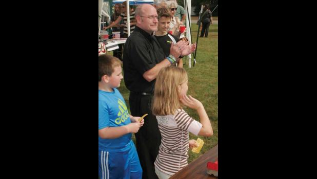 Father Mike cheers on the kids as they play games. Also take notice of the Viking bracelet he is wearing.