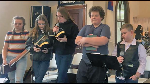 Kaylee Erickson, Dashton Mueller, Bladen Mueller, Nicholas Sakry and Carter Johnson read their parts during the Snake River Church Christmas program. (Photos by Mary Nehring).