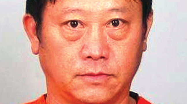 FIFTY-ONE-YEAR-OLD ZHA VANG of Elk River (right photo) fired shots into the front door windows of the Sherburne County Government Center last Saturday. (Submitted Photo).