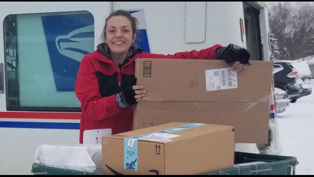 THE MAIL NEVER SLEEPS. Becker mail carriers have been inundated with Christmas letters and deliveries to the point of delivering packages starting at 5am. Pictured is Annie Auburn about to start her route on a blustery wintry day. (Photo by Mary Nehring).