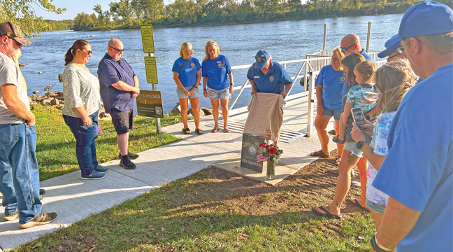 BECKER LIONS MEMBER Kurt Anderson unveiled a granite slab in honor of long-time member Jim Hazeltine whose two children were in attendance last Thursday. (Patriot Photo by Mark Kolbinger.)