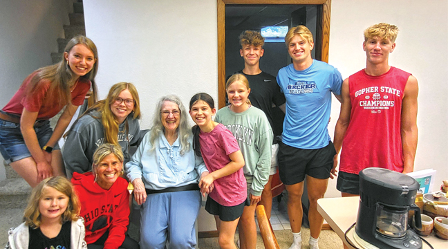 SOME OF THE YOUTH GROUPS AND ADULT AIDS gathered around an elderly woman who appreciated the help she received from the devoted assembly. (Submitted Photo).