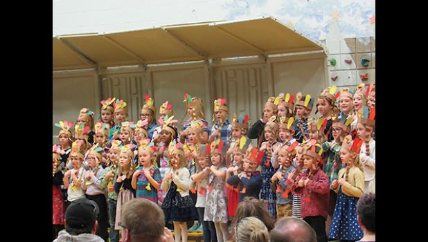 WEARING CONSTRUCTION PAPER TURKEY HATS, Becker Primary School first-graders sing about thankfulness during their concert Thursday afternoon. (Photo by Penny Leuthard)