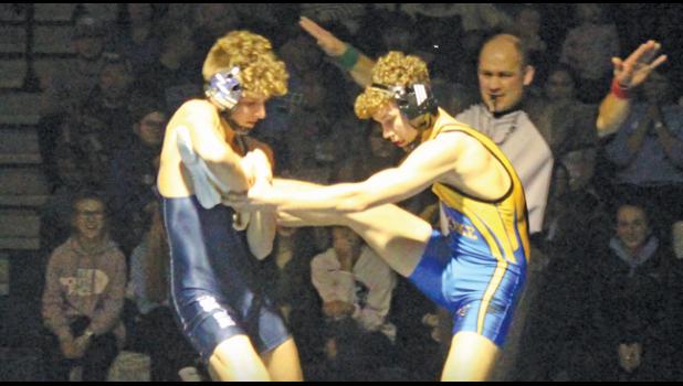 BECKER’S JACK NELSON goes for the takedown against the Hornets’  Luke Schumacher during the 132 pound match. (Photo by Mark Kolbinger)