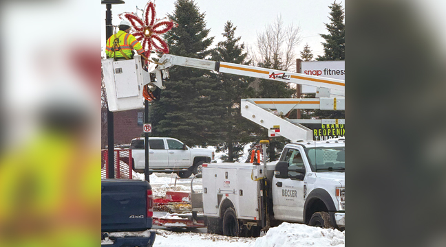 FIVE DAYS AFTER THE NEW YEAR COMMENCED, Becker crews were seen out along Bank Street removing the street pole decorations that featured snowflakes, stockings, stars and poinsettias. (Patriot Photo by Bill Morgan).