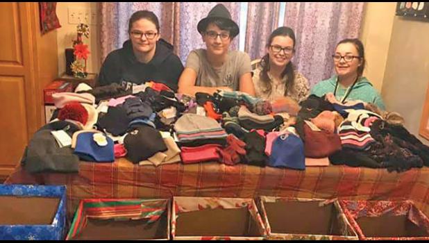 GIRL SCOUTS GIVE BACK. Becker Girl Scout Troop #334 collected winter hats, mittens, scarves and socks for people in need in the Becker area. Pictured: Bailey Klinker, Ellie Christensen, Allie Reynolds, Katelynn Struffert. (Submitted Photo).