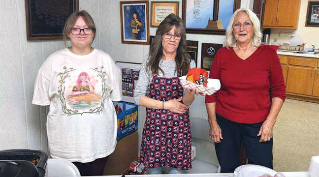 Aevah Pop, Nellie Simpson and Wanda Herkenhoff  were ready to greet the public who came to the Becker Legion’s walking taco lunch last Friday. (Patriot Photo by Mary Nehring).