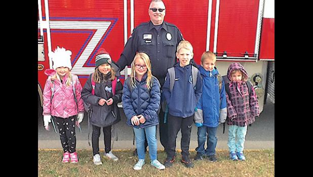 BECKER FIREFIGHTER and Public Education Officer Ron Kortz with the first group of Becker Primary School coloring contest winners Kaisa McGowan, Finlee Esping, Emma Aaseby, Jonathan Plantenberg, Dylan Warzecha and Prya Gram. (Submitted Photo)