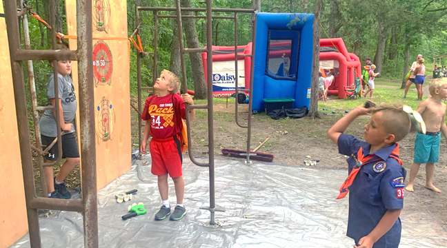 SCOUT DAY GAVE KIDS a chance to try out a variety of activities, like axe throwing (designed for kids). (Photo by Penny Leuthard.)