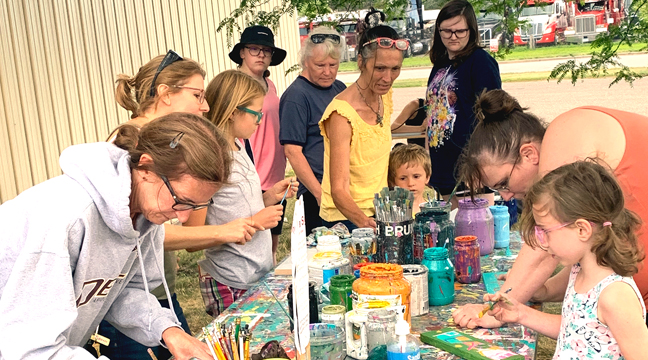 PATRONS OF ALL AGES stopped by the Clearwater Library recently to create their own personal signs. (Photo by Penny Leuthard.) 