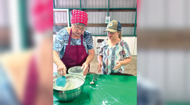 During the Benton County 4-H Pie Day, 4-H volunteer Barb Bemboom took the lead showing the 4-H youth how to make pie crusts. Pictured here Barb (left) is working with Hailey Meilke (right) the best way to work the dough. (Submitted Photo).