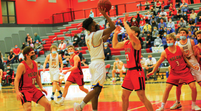 TREY GORDY went up for a jump shot against Rocori defenders during the March 19 quarterfinal game on the road. Rocori won 72-58 to advance. Gordy finished with four points. (Photos by Patti Bottema)