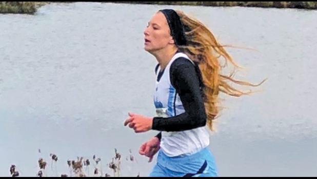 SENIOR LEXI DEHMER sprints to the finish line during the conference championship meet, placing 3rd and securing a place in the upcoming section meet. (Submitted Photo)