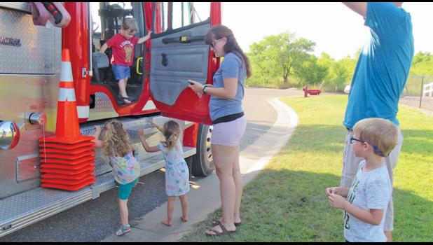 THERE WAS A LINE OF KIDS eager to explore the Clear Lake Fire Dept.’s fire truck Tuesday night. (Photos by Penny Leuthard)
