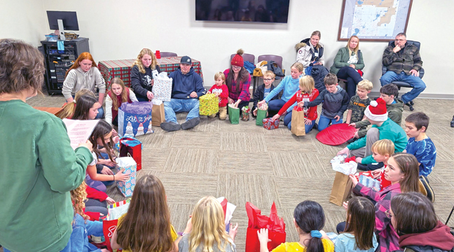 Club members play the Right/Left game to exchange gifts. (Submitted Photo).