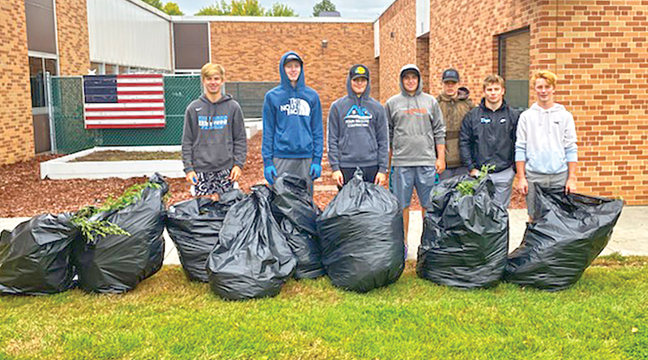 A NUMBER OF BECKER FOOTBALL PLAYERS did community service last Saturday as a fundraiser for the program. The student/athletes washed equipment, cleaned storage rooms, picked weeds and picked up trash around the school and city properties. (Photos by Sara Waytashek)