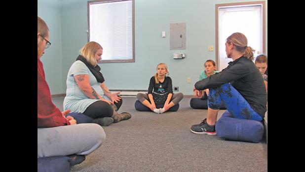 AMY PEINE from the Central MN Sexual Assault Center speaks to participants of the self defense class at Light Body. (Photo by Penny Leuthard)
