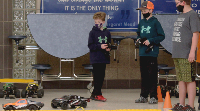 SEVERAL STUDENTS practiced maneuvering the RC cars before their race started. (Photo by Katherine Cantin.)