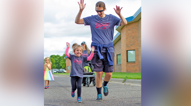 Cortney Asher, Becker, and daughter, Ruth, celebrate as they cross the finish line. (Submitted photo.)