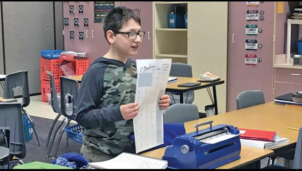 BECKER STUDENTS LEARN BRAILLE. Students in Mrs. Kensy's fourth grade class had their very own classmate, Jake C. (top photo), give a presentation on Braille. He shared with them the alphabet and numbers, as well as how to use the Brailler (Braille typewriter). He also showed them how to use a menu in braille! Jake answered many questions and showed them a few tools he has been using to learn Braille. Students (lower photos) were able to write their name in Braille, as well! Braille is a tactile writing syst