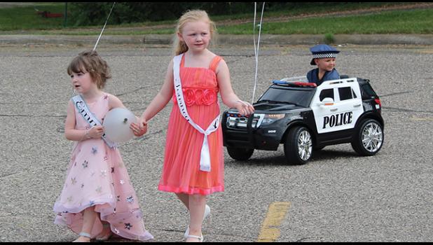 EMMA VRCHOTA and Journey Roering (top right) had (Corbin W.) as their own personal police escort  during the Kiddie Parade.