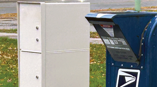 The blue collection box formerly located near Bill’s Superette at the former post office has now been relocated to Becker City Hall, serving as a drop off for those wishing to mail items. (Submitted Photo).