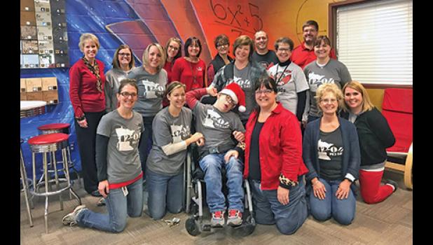 SEVERAL VOLUNTEERS and supporters of the Schmidt family gathered to celebrate PKS Day, Dec. 4 for all the PKS kids including Andrew Schmidt (center). (Submitted Photo).