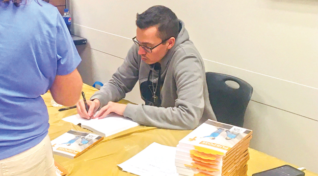  Soltau signs copies of his new book at the Monticello Community Center where he had a book signing a couple weeks ago. (Patriot Photos by Andrew Diemand).