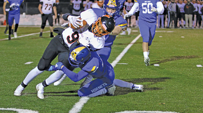 HORNET DEFENDERS, Reed Bottema and Blayne Kildahl dragged down Marshall RB Bryce Lance during last Wednesday’s final regular season game of the year. (Submitted Photo).