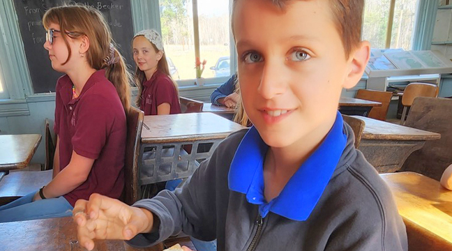 Lucas Dumont enjoyed butter the students made. (Photo by Mary Nehring.)
