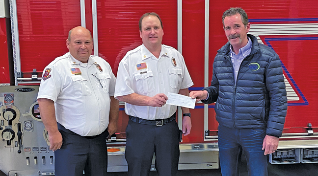 NORTHERN METALS COO SCOTT HELBERG (R) presented the $30,000 check to Becker Fire Chief Doug Kolbinger (M) and Asst, Chief Jeff Edling (L). (Submitted Photo)