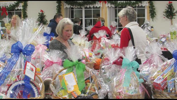 WITH 147 SILENT AUCTION BASKETS, there was something for everyone to bid on during Camp Friendship’s annual holiday party. (Photo by Penny Leuthard)