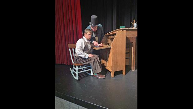 Bob Cratchit (Jonathan Norberg) receiving a ‘scolding’ from Ebenezer Scrooge (Jerry Gudim). (Submitted Photo).