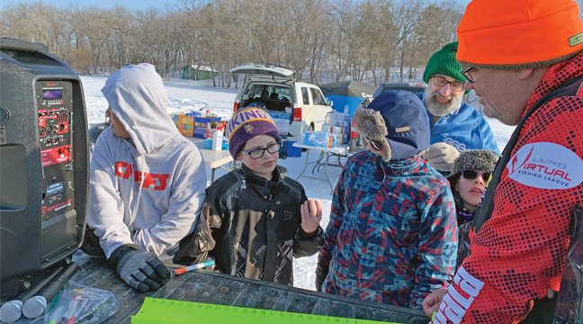 A Member of the Royal Rangers church group explained to Dusty Wright (R) how he caught his fish. (Submitted Photo).
