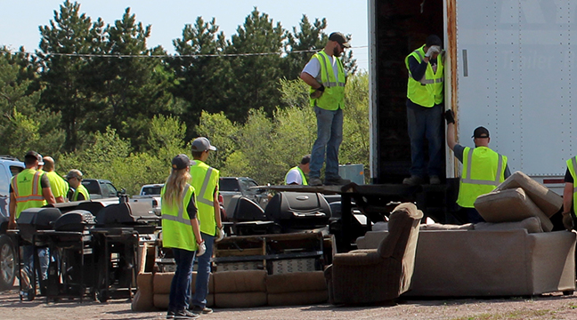 VOLUNTEERS AT BIG LAKE’S ANNUAL RECYCLE DAY collected lots of tires, furniture, and appliances.  (Photo by Katherine Cantin.)
