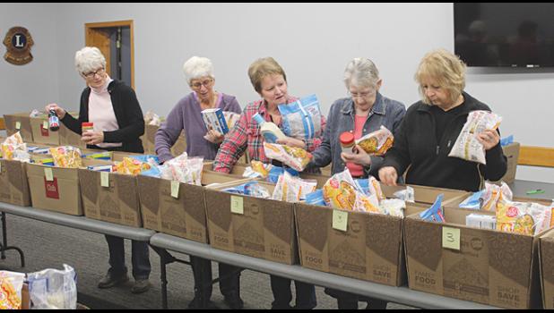  Volunteers filled boxes with Thanksgiving meals at the Clearwater-Clear Lake Food Shelf Monday. From left, Kathy Langva, Karen Lietha, Linda Allen, Mary Lenk and Mary Abraham. (Photo by Ken Francis.)
