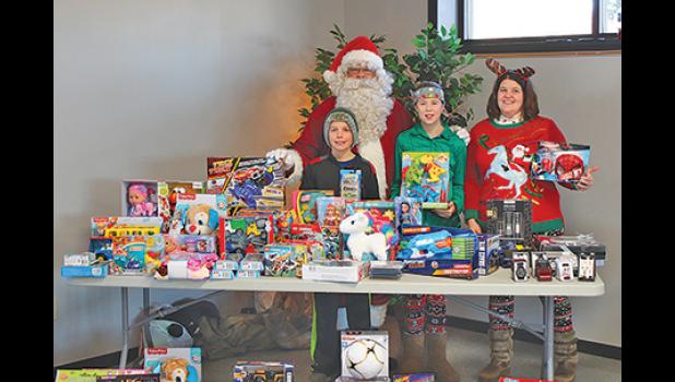 Santa and his elves handed out Christmas gifts to kids at the Clearwater-Clear Lake Food Shelf Monday. (Photo by Ken Francis.)