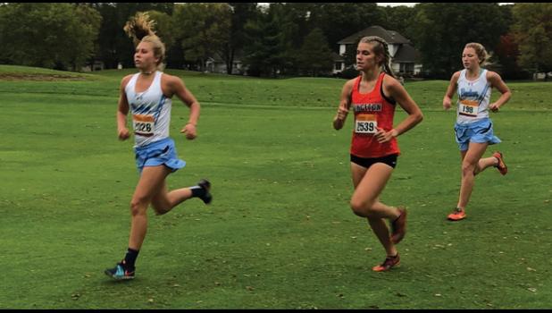 DANI NUEST AND LEXI DEHMER push themselves during the Bulldogs’ home meet on Tuesday, helping lead their team to a first place win. (Submitted Photo)