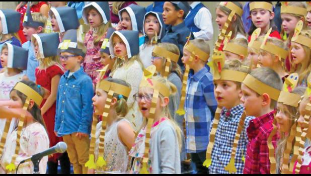 DONNING FUN PAPER HATS, BPS first-graders sing about thankfulness during their concert last week. (Photo by Penny Leuthard)