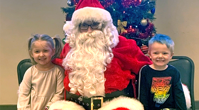 FOUR-YEAR-OLD BRYNLEE CRAWFORD and five-year-old Jace Terzich came to visit Santa with their dads. (Photo by Penny Leuthard.)