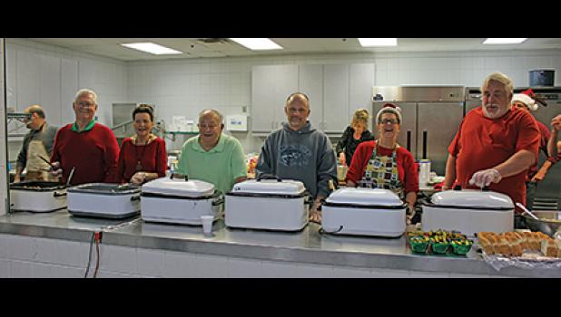 APPROXIMATELY 25 volunteers spent Christmas Day slaving over hot food in a warm kitchen to serve guests at the seventh annual Christmas Day Dinner event held at the BCC. (Photos by Bill Morgan).