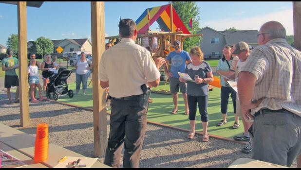SHERBURNE CO. SHERIFF JOEL BROTT speaks with attendees at the Hunter Lake Bluffs Neighborhood’s Night to Unite event. 