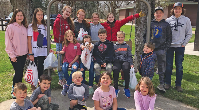 Local 4-H group, Home Explorers, picked up trash along the Becker City Park trails recently, as they learned about Earth Day. Standing-Ava Babler, Brooklyn Westby, Susannah Larson, Lilly Hales, Sophie Hales, Maria Larson, Will Hales, Johnny Friedman, Owen Babler. Sitting on bench: Ily Babler, Josie Hales, Sam Hales, Ezra Babler. Sitting on ground Fallon Schoepf, Thomas Cunningham, Levi Schoepf, Savannah Cunningham and Chloe Schoepf. (Submitted Photo). 
